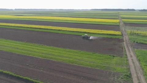 Drone Ark Dolly Shot - tractor fertilizing agricultural fields Stock Footage 148397955