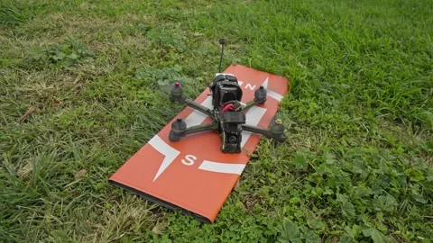 Drone Arming Process Captured on a Grass Launch Area Stock Footage 321338347