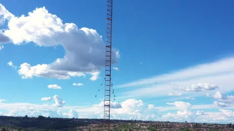 Drone ascend deactivated tower ladder rungs brackets antenna sky cumulus clouds Stock Footage 325854340