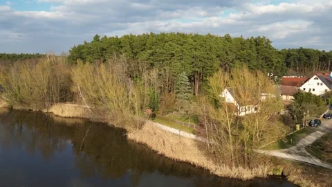 Drone Ascending Above Lakeside Forest and Rural Homes in Germany Stock Footage 341736601