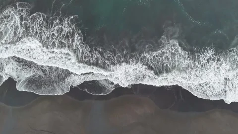 Drone ascending above Pacific Ocean waves and black sand tropical beach Video stock 338311766