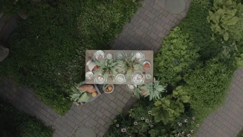 Drone ascending above pumpkin tableware installation Stock Footage 329833497