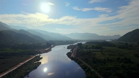 Drone Ascending Above Winding River and Mountain Valley 스톡 동영상 336857093