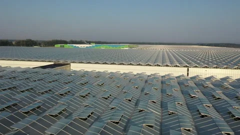 Drone ascending after low flight over greenhouses Stock Footage 328336740