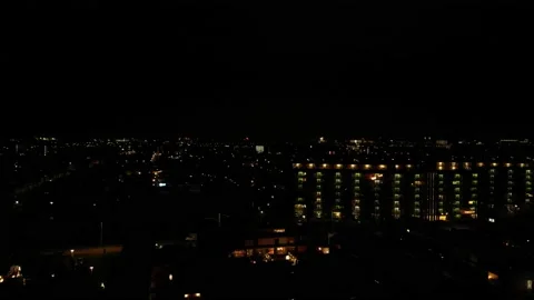 Drone Ascending On The Cityscape At Night With Exploding Fireworks In Stock Footage 232501320