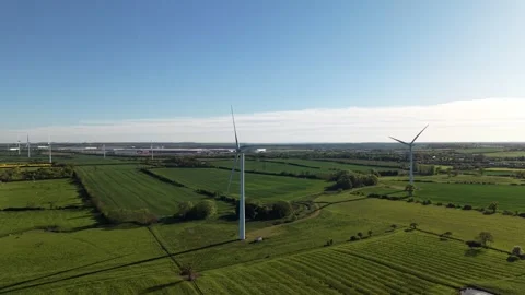Drone ascending forward towards wind turbine over countryside fields Stock-Footage 333935946