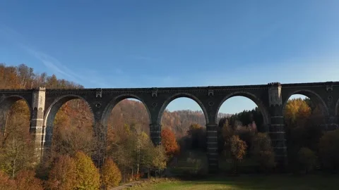 Drone Ascending in Front of Ancient Stone Viaduct Revealing Mountain Forest Stock Footage 320840068