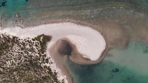 Drone ascending over cross on beach in Greece Stock Footage 331709834