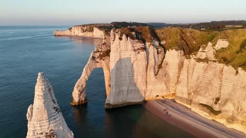 Drone ascending over Etretat cliffs, golden hour sunset, dramatic chalk 動画素材 346477118