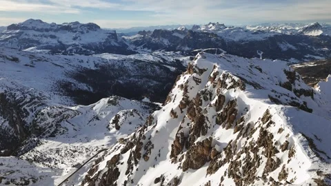 Drone ascending over a mountain ridge covered with snow. Dolomites, Italy Stock Footage 270099591