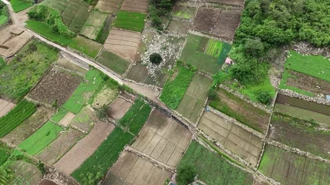 Drone Ascending Over Patchwork Mountain Farmland in Zunil Stock Footage 344162835