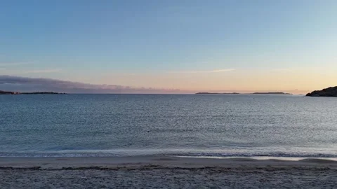 Drone Ascending Over Sardinian Beach at Sunrise with Gentle Waves Stock Footage 334796567