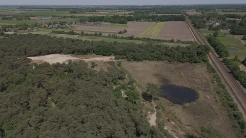 Drone Ascending Pullback Shot of Rural Railway Through Lush Green Countryside Stock Footage 310439737
