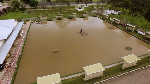 Drone ascending to show flooded bowling green after a major flood. Stock Footage 93265574