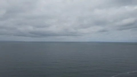 A drone ascending to the sky over the ocean. Stock Footage 276489262