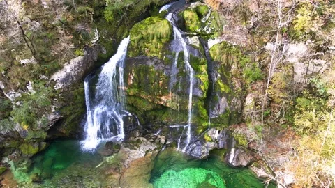 Drone ascending with tilt down revealing Virje Waterfall and emerald pool in Stock Footage 342317751
