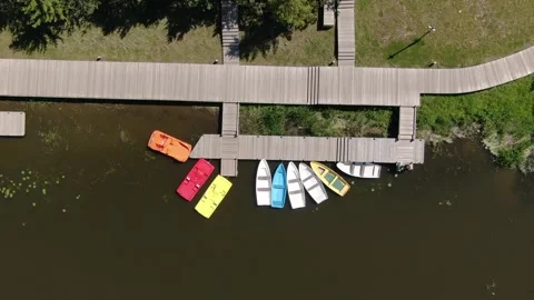 Drone ascending vertically above dock with moored boats Stock Footage 331829270