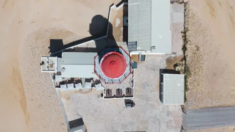 Drone Ascending Vertically Above Lighthouse on Sandy Beach Stock Footage 306256427