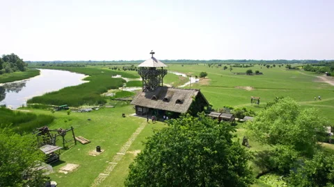 Drone ascends from behind tree and captures tourists and shop in nature reserve Stock Footage 263139833