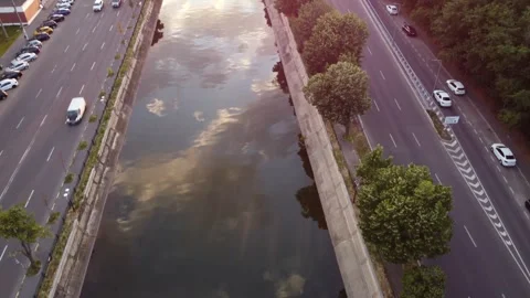 Drone ascends over river reflection to ciurel bridge at sunset Stock Footage 312704237