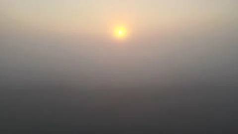 Drone ascends through low mist at sunrise Stock Footage 164597512