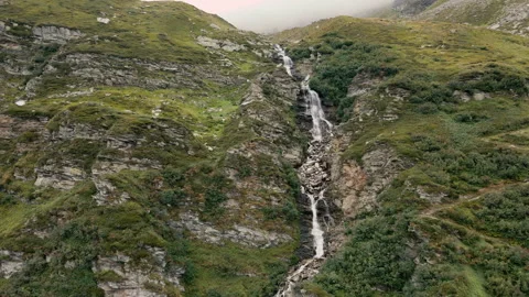 Drone ascension in front of a mountain stream waterfall in Madesimo Vídeos de archivo 251564878