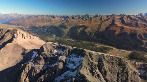 Drone ascent above rocky alpine ridge with valley view Stock Footage 336333390