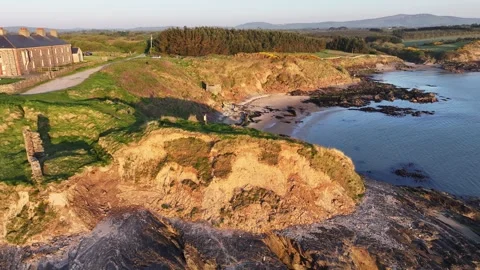 Drone ascent from bare cliff rocks to Kilmichael Point, Stock Footage 313981371