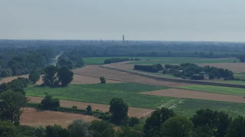 Drone ascent establishing Cremona skyline with Torrazzo above the Po Valley Stock Footage 340604178