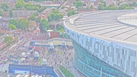Drone ascent over crowds and matchday activity outside Tottenham Hotspur Video stock 342735513
