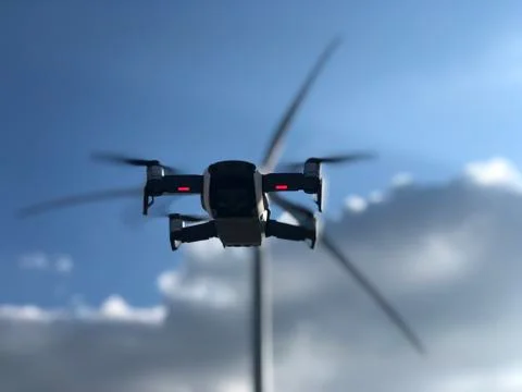 Drone on the background of a windmill and sky DJI mavic air white Stock Photos