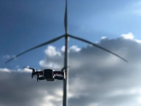 Drone on the background of a windmill and sky DJI mavic air white Stock Photos