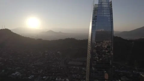 Drone Backlight Shot With Sun Over Hills And Gran Torre Santiago Stock Footage 345606470