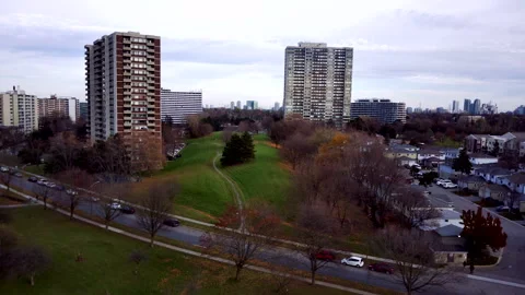 Drone Backs Away from High-Rise Building Toward Park Stock-Footage 347151279