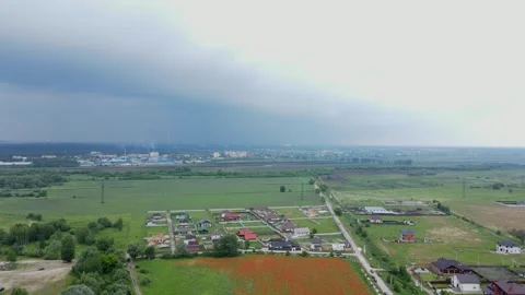 Drone Backward Flight Revealing Red Poppy Field, Blue Lake, and Mesmerizing Sky. Stock Footage 310764989