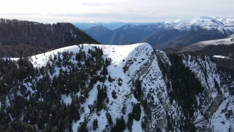 Drone backward movement over snowy mountains in France Stock Footage 331709876
