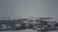 Drone backwards shot snow white gray foggy winter weather at village landscape 4k or 4k+ Resolution
