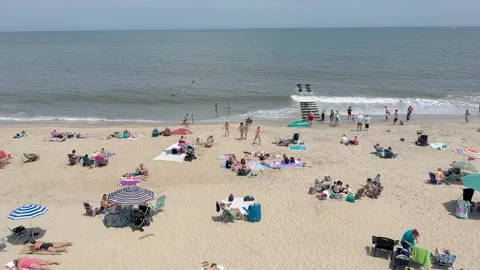 Drone Beach Fly Over Summer Day Sunbathing and Playing in the ocean 動画素材 241113999