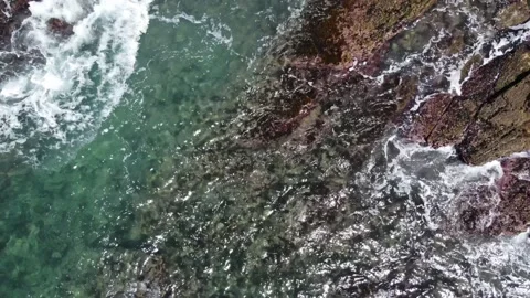 Drone beach shot of waves crashing on the rocks Video stock 169096566