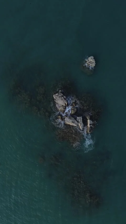 Drone Bird’s Eye View 4K: Moody Ocean Waves Crashing Against Rocky Sea Reef Stock Footage 343480022