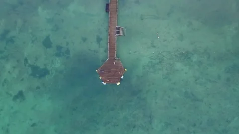 Drone bird's eye view over a dock in the Caribbean ocean. 스톡 동영상 244822820