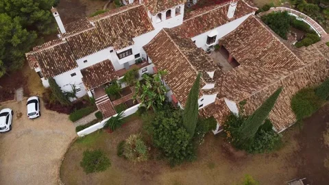 Drone bird's-eye view panning right to left while turning, revealing a classic w Stock Footage 304972371