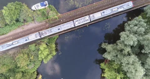Drone birdseye view of a train crossing a river bridge Stock Footage 205330446