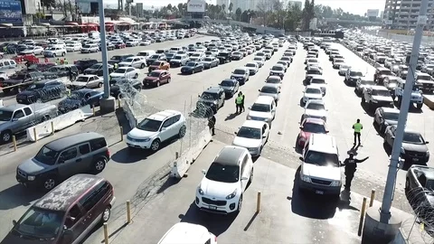 Drone of border guards standing between cars at California and Mexican border Video stock 98989209