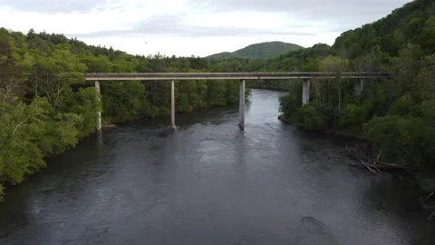 DRONE Bridge Shot Mountain Range in background Stock Footage 130223931