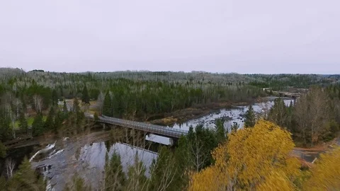 Drone camera approaches a bridge between the shores with a road Video stock 126079551