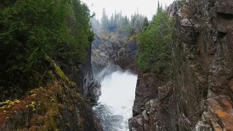 Drone camera approaches stormy waterfall in wooded hills. Aguasabon Falls Video stock 126078029