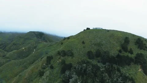 Drone camera approaching a large house on the top of a mountain range Video stock 136061364