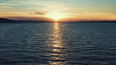 Drone camera fast forward to the horizon a golden sunset of a sunny day Stock Footage 105008135