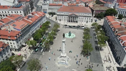 A drone camera flies around the Dom Pedro IV Square in Lisbon Stock Footage 202016838